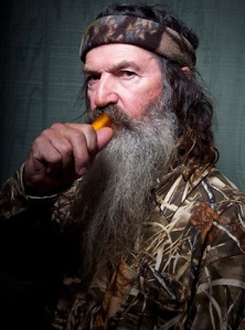 Phil Robertson portrait.  We can safely assume that phallic object in his mouth is a duck call or a carrot.  (Image from college-football dot si dot com)